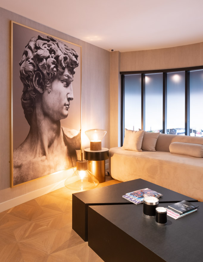 A luxurious waiting area with relaxing lighting conditions inside of a commercial property.