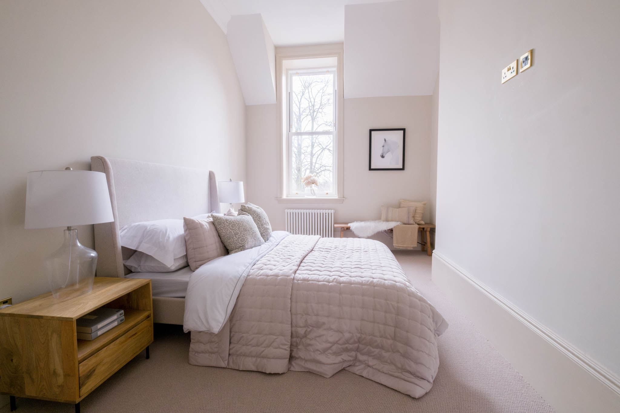 A wide-angle photography of a spacious bedroom in a Gloucestershire based residential property.