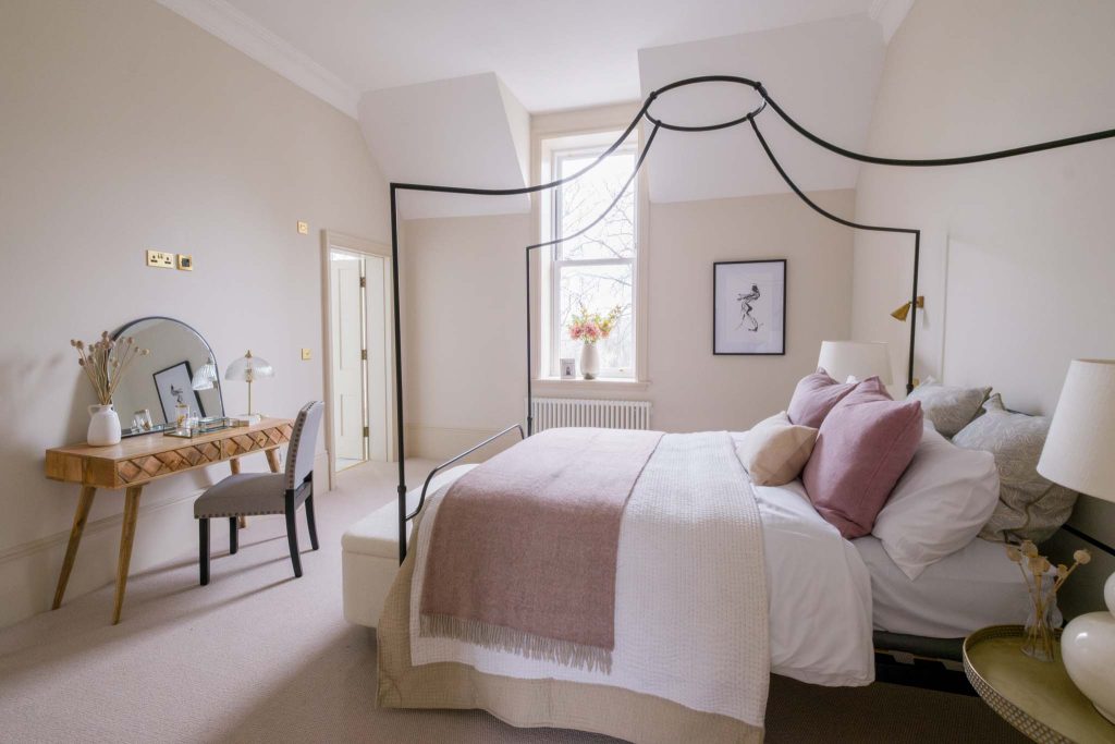 A wide-angle photography showcasing a luxurious bedroom in a Gloucestershire residential property.
